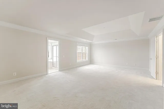 a bathroom with a tub a window and a shower
