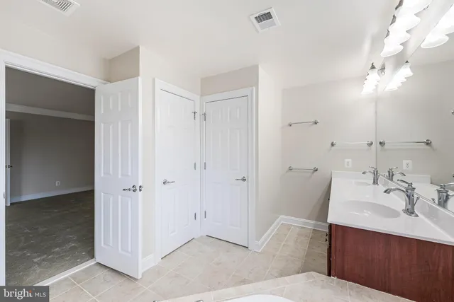 a bathroom with a tub sink and mirror