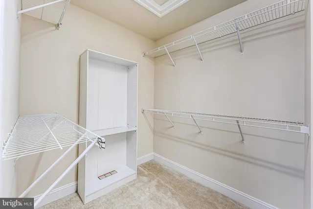 an empty room with a ceiling fan and a window