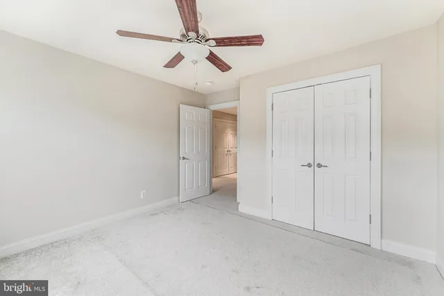 an empty room with closet and a bathroom
