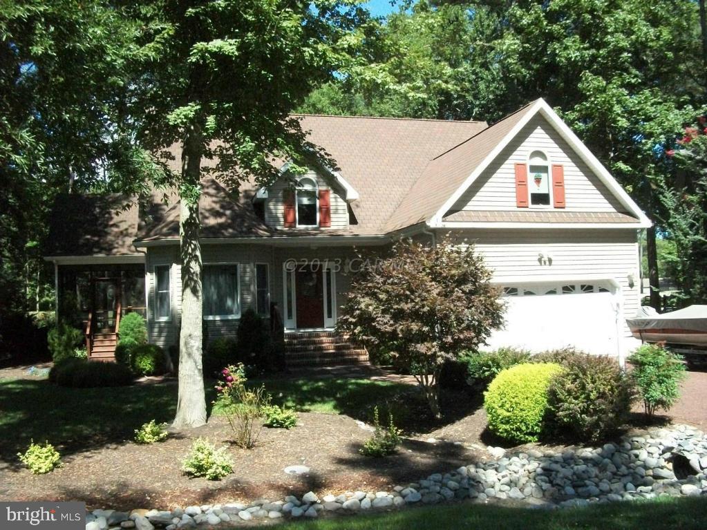 273 Windjammer Road Ocean Pines, MD 21811 - Photo 1 of 33 a view of a white house next to a yard with potted plants