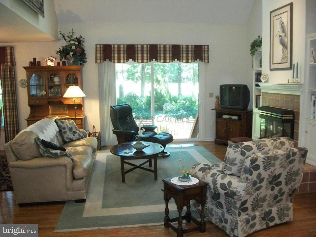 273 Windjammer Road Ocean Pines, MD 21811 - Photo 2 of 33 a living room with furniture and a fireplace