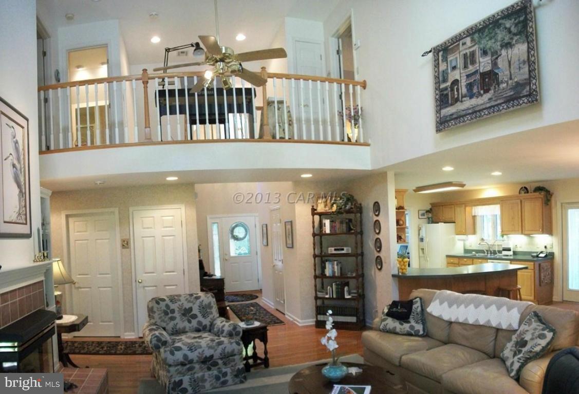 273 Windjammer Road Ocean Pines, MD 21811 - Photo 6 of 33 a living room with furniture a dining table a rug and a window