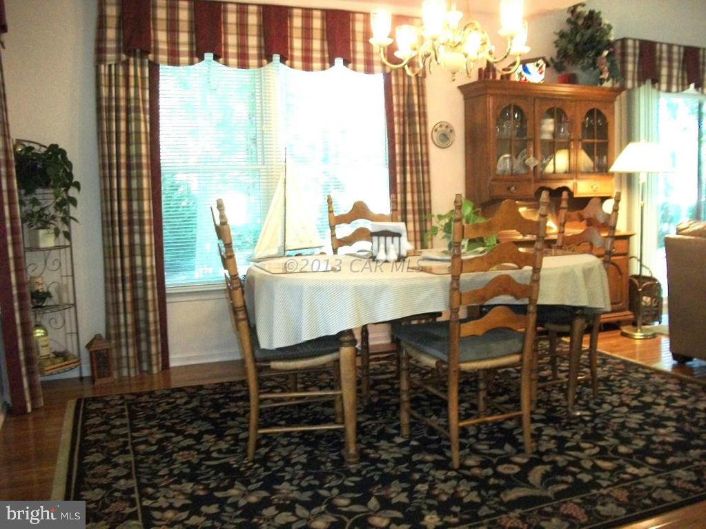 273 Windjammer Road Ocean Pines, MD 21811 - Photo 9 of 33 a dining area with glass top table and chairs
