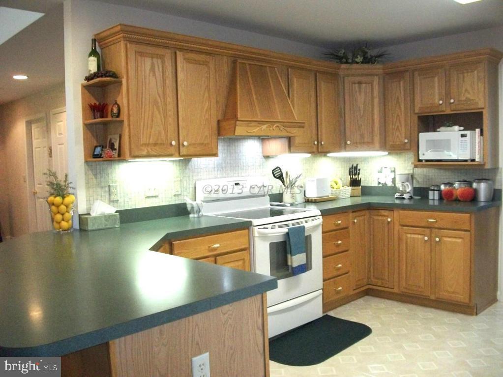 273 Windjammer Road Ocean Pines, MD 21811 - Photo 10 of 33 a kitchen with stainless steel appliances granite countertop a sink stove and cabinets