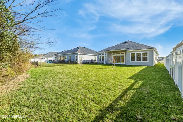 a view of a room with wooden floor and a window