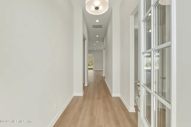 a large white kitchen with kitchen island a sink a center island stainless steel appliances and a cabinets