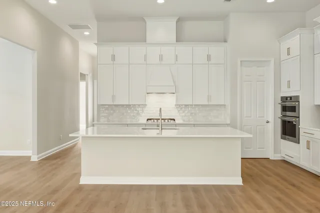 a bathroom with a white bath tub sitting next to a window