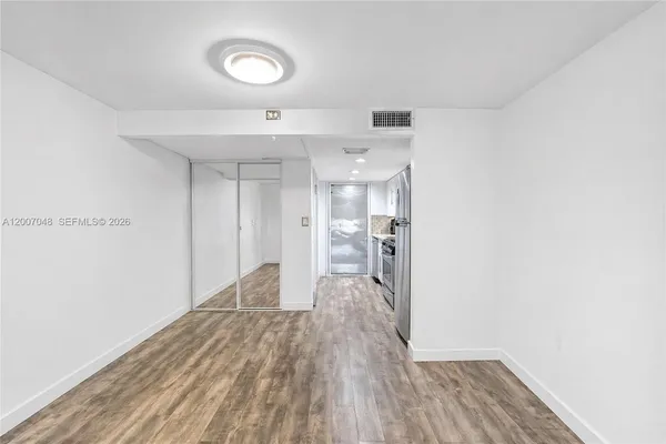 a view of a room with wooden floor