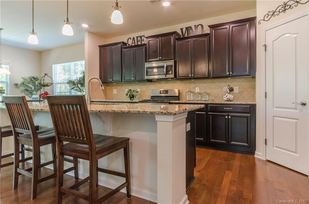 4155 Perth Road Indian Land, SC 29707 - Photo 3 of 24 a kitchen with stainless steel appliances granite countertop a sink a stove a table and chairs