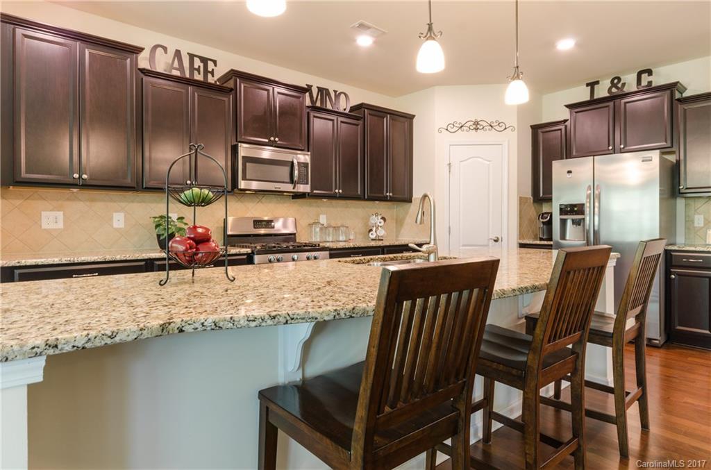 4155 Perth Road Indian Land, SC 29707 - Photo 4 of 24 a kitchen with stainless steel appliances granite countertop a sink refrigerator and microwave