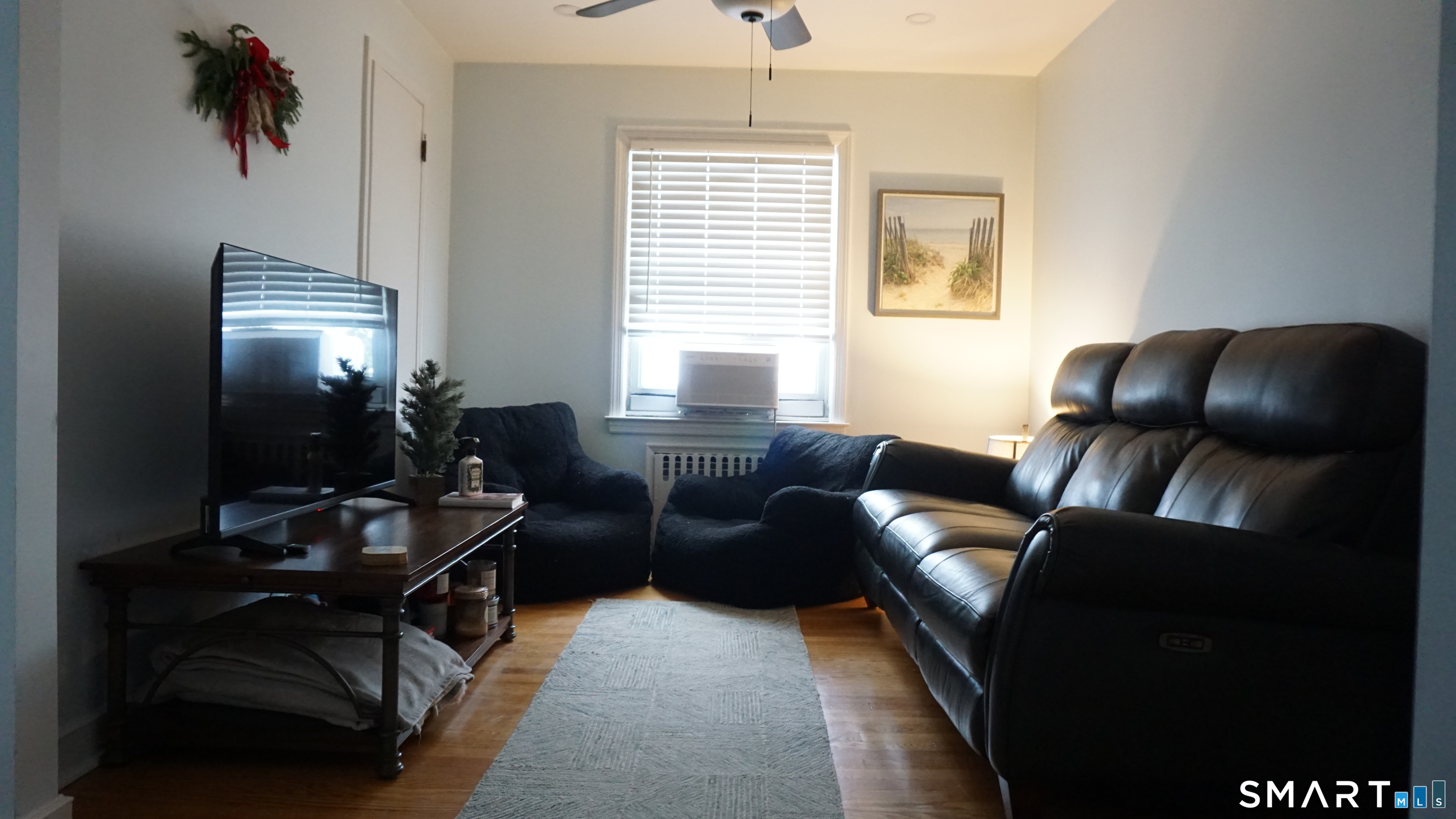 228 Jennings Road Fairfield, CT 06825 - Photo 13 of 22 a living room with furniture a chandelier and a window