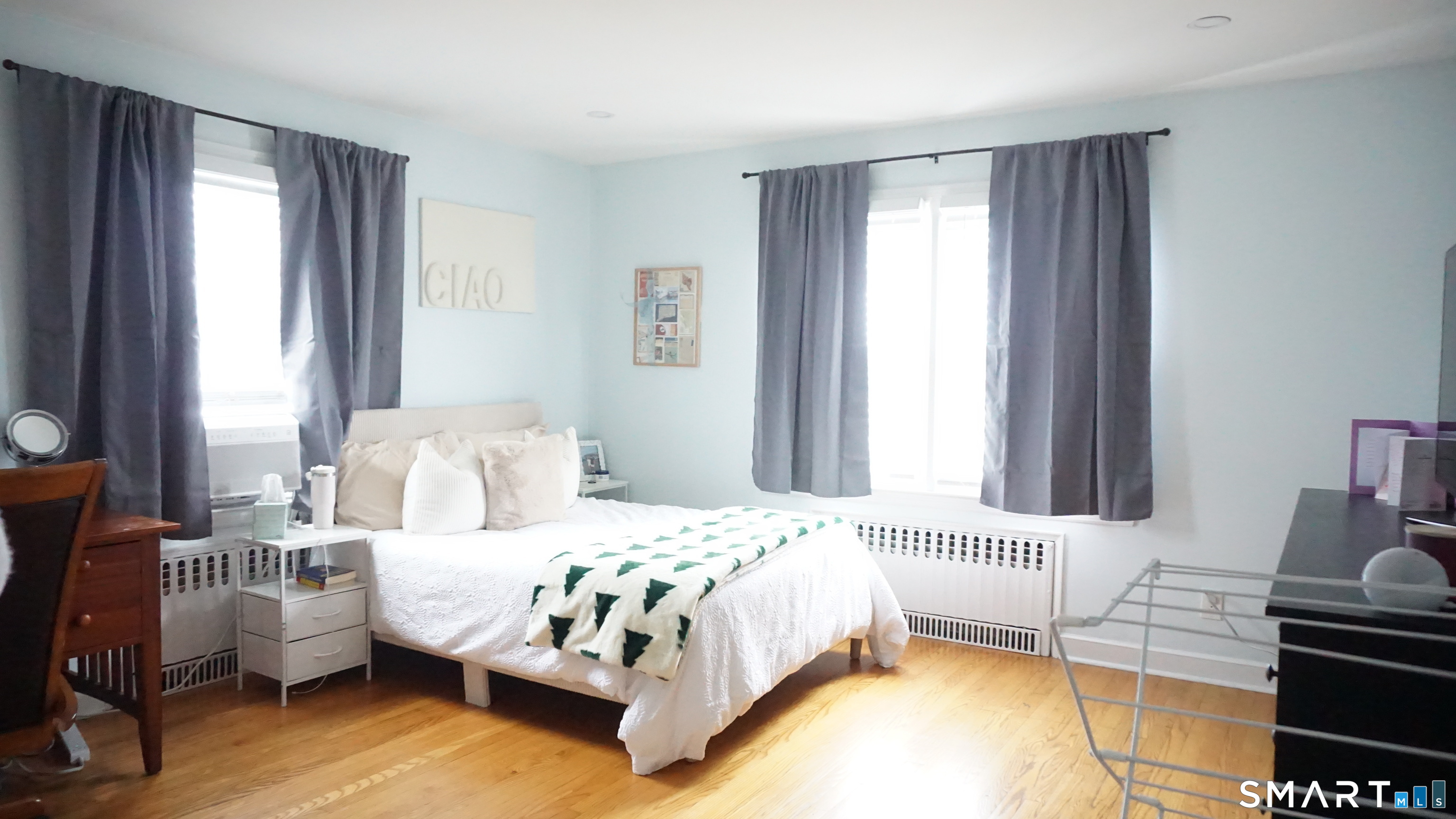 228 Jennings Road Fairfield, CT 06825 - Photo 16 of 22 a bedroom with a bed and wooden floor