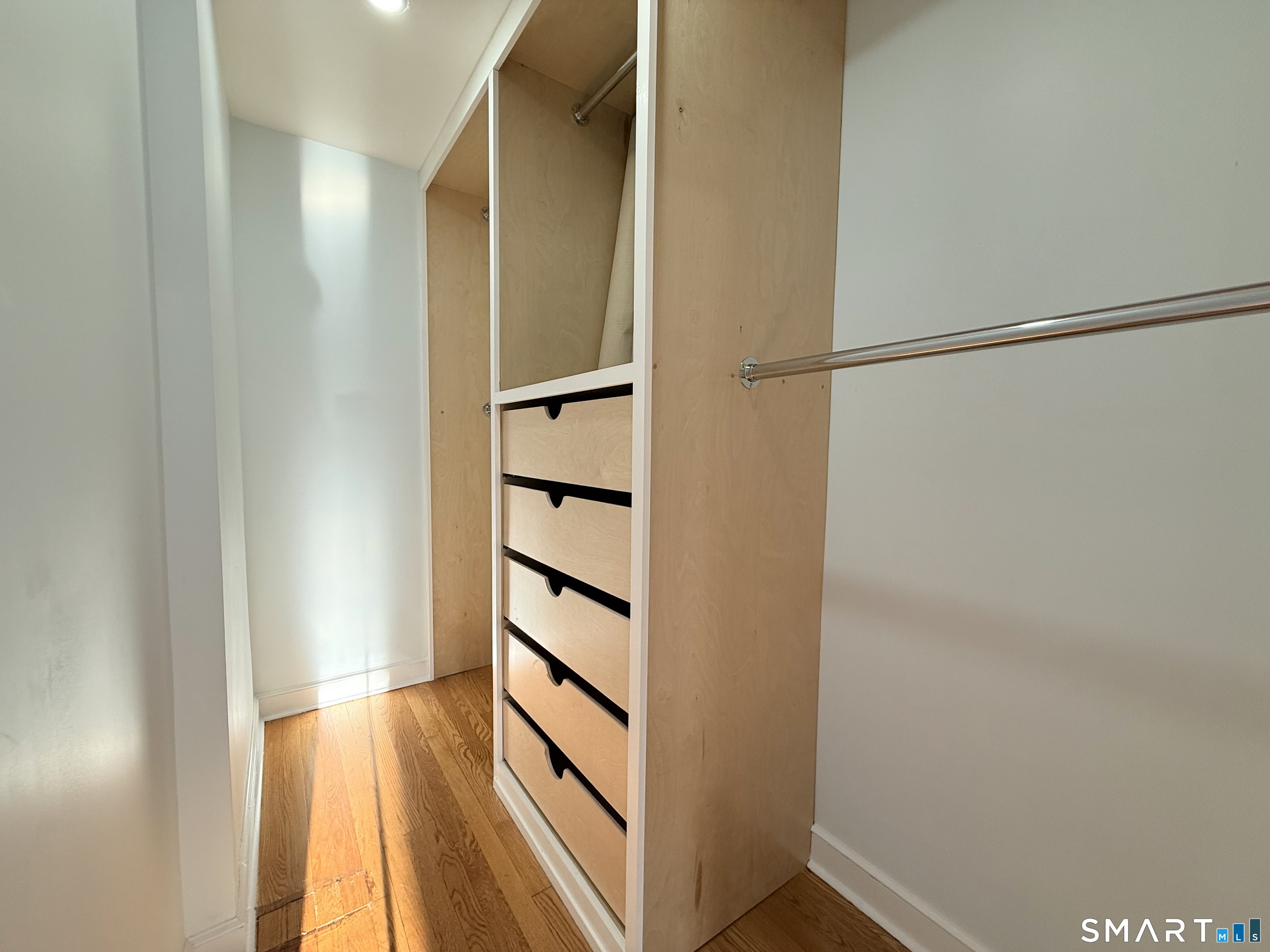 228 Jennings Road Fairfield, CT 06825 - Photo 6 of 22 a view of walk in closet with empty racks