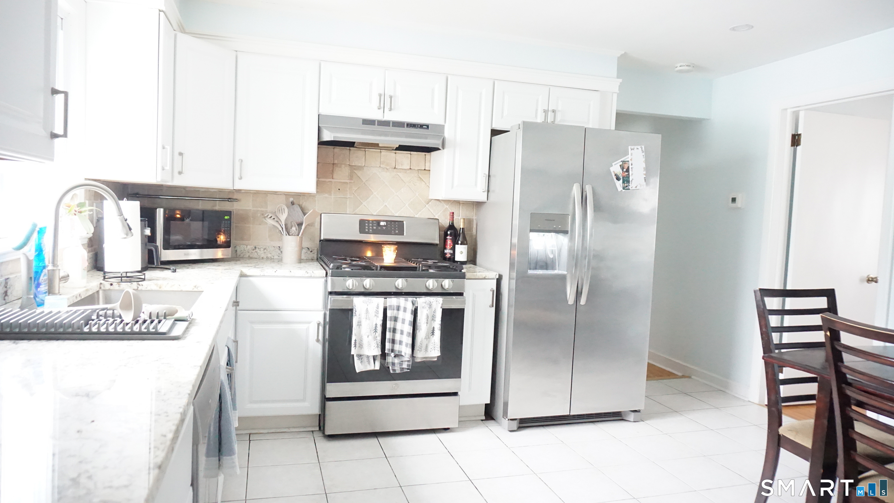 228 Jennings Road Fairfield, CT 06825 - Photo 10 of 22 a kitchen with stainless steel appliances granite countertop a refrigerator and a stove