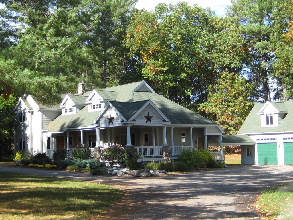 a front view of a house with yard patio and lake view