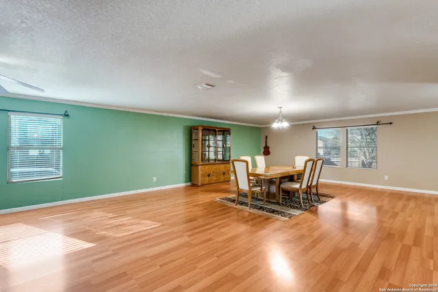 a dining room with furniture and wooden floor