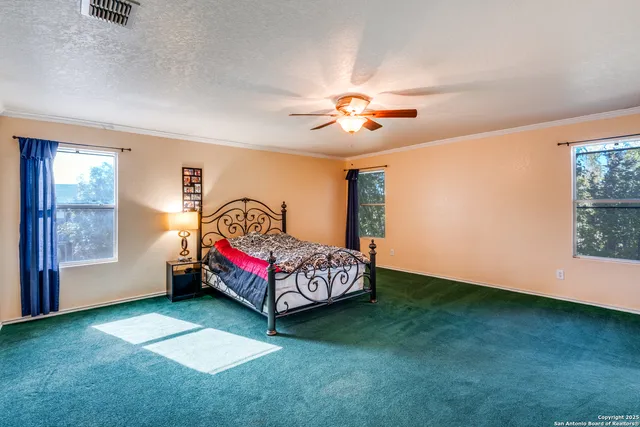 a spacious bedroom with a bed and a window