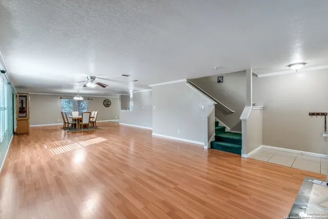 a view of a livingroom and a kitchen with wooden floor