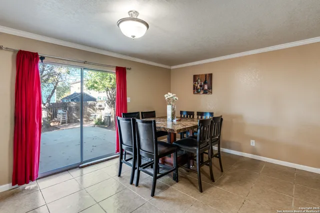 a view of a dining room with furniture and a window