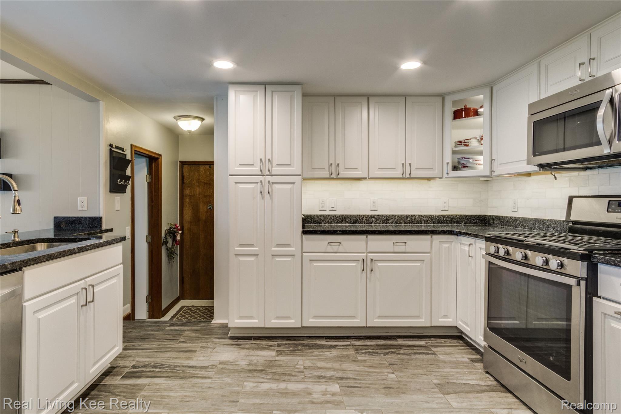 797 Redwood Court Rochester, MI 48309 - Photo 7 of 40 Tile floors, granite countertops, and stainless appliances