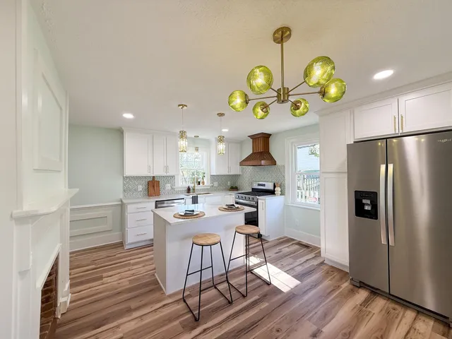 a kitchen with a table chairs and a refrigerator