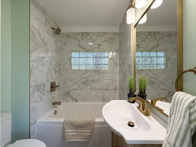 an empty room with fireplace and wooden floor