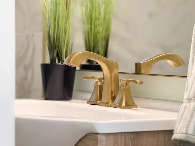 an empty room with wooden floor fireplace cabinet and windows