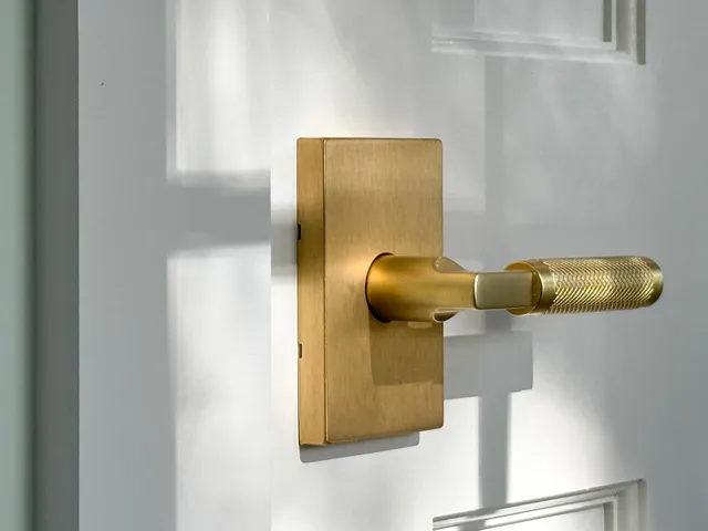 an empty room with windows a fireplace and wooden floor