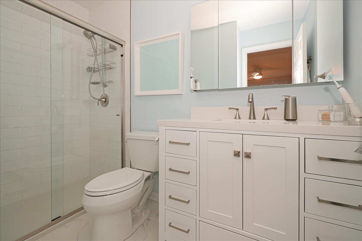 3481 Ravinia Circle Aurora, IL 60504 - Photo 15 of 28 a bathroom with a sink a toilet and shower