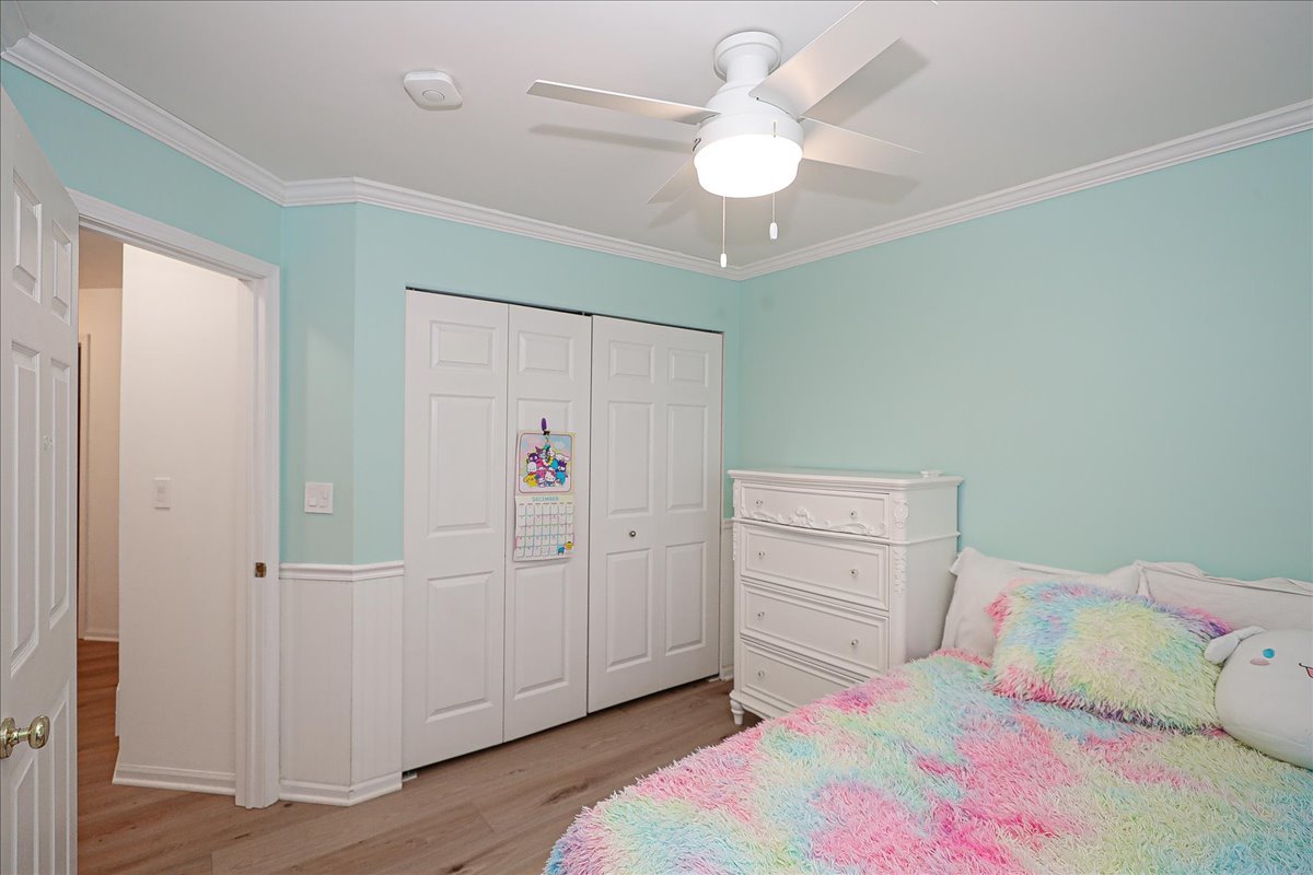 3481 Ravinia Circle Aurora, IL 60504 - Photo 20 of 28 a bedroom with a bed and a chandelier