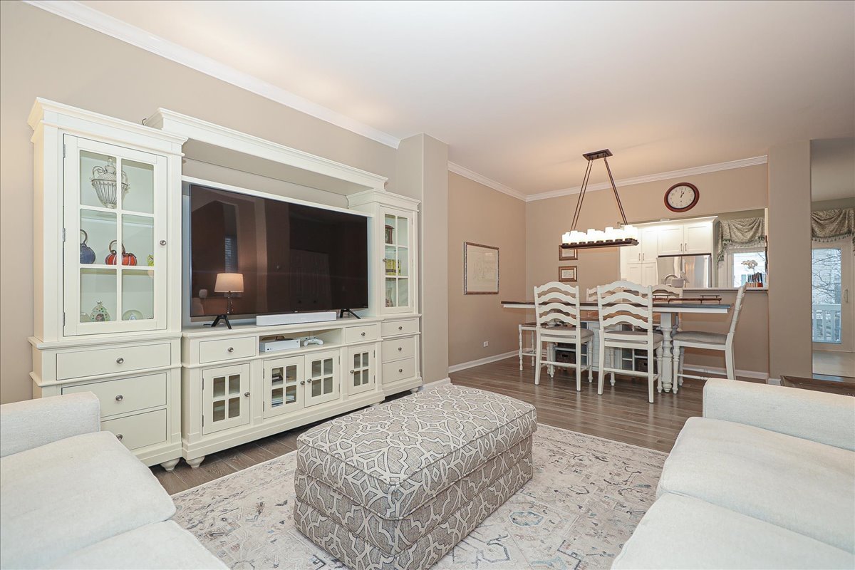 3481 Ravinia Circle Aurora, IL 60504 - Photo 5 of 28 a living room with furniture a flat screen tv and kitchen view