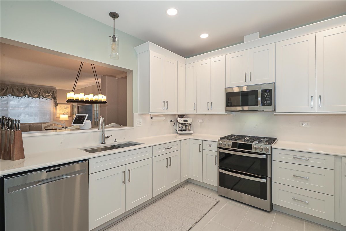 3481 Ravinia Circle Aurora, IL 60504 - Photo 10 of 28 a kitchen with a sink stove and microwave