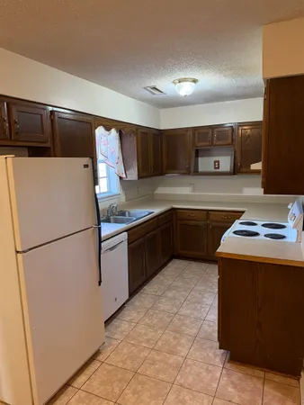 a kitchen with stainless steel appliances granite countertop a refrigerator sink stove and microwave