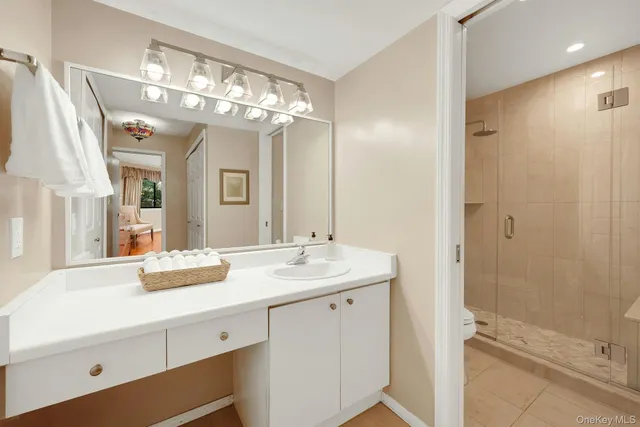 a bathroom with a sink a large mirror and shower