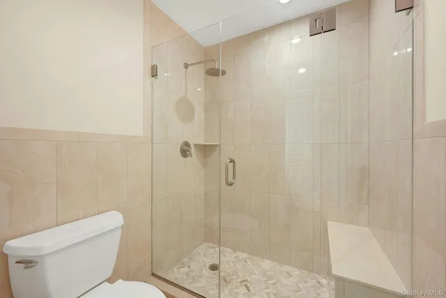 a bathroom with a shower a toilet and sink