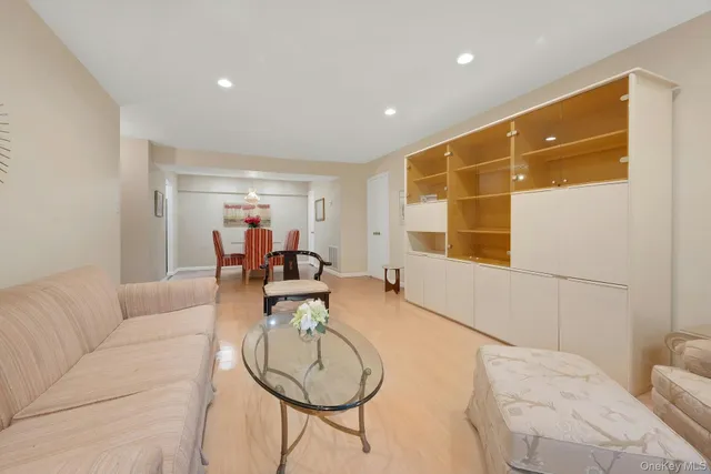 a living room with furniture a table and a window