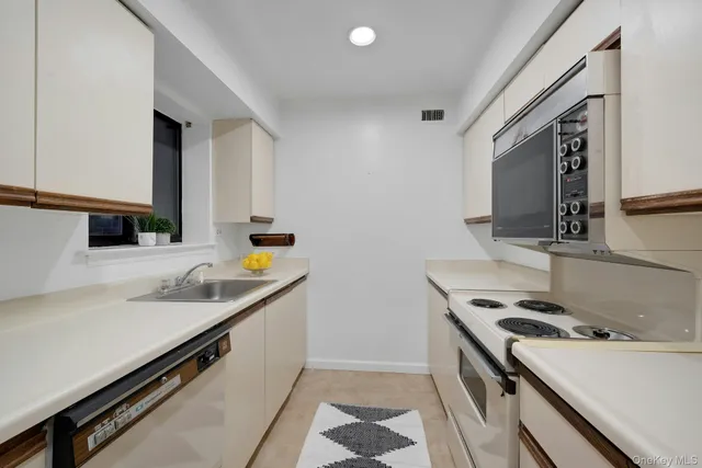 a kitchen that has a sink and a stove in it