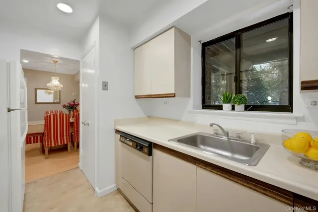 a kitchen with a sink and a large mirror