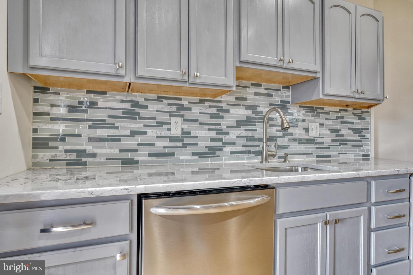 1754 Clarkson Street Baltimore, MD 21230 - Photo 13 of 35 a kitchen with stainless steel appliances granite countertop a sink and cabinets