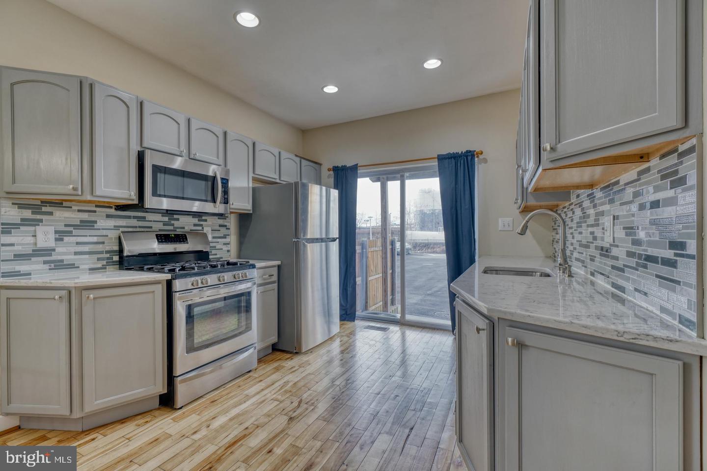 1754 Clarkson Street Baltimore, MD 21230 - Photo 16 of 35 a kitchen with stainless steel appliances granite countertop a stove a sink and a refrigerator
