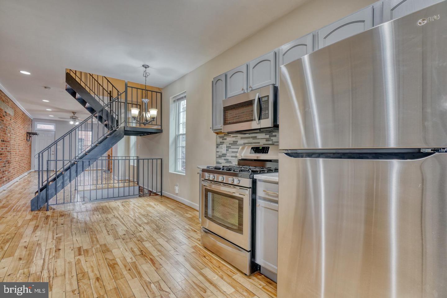 1754 Clarkson Street Baltimore, MD 21230 - Photo 17 of 35 a kitchen with wooden floor electronic appliances and furniture