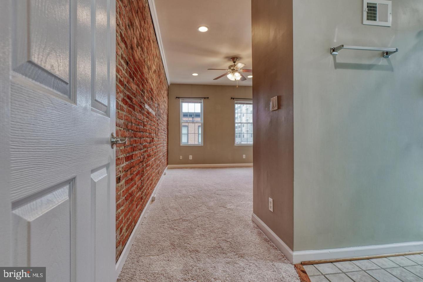 1754 Clarkson Street Baltimore, MD 21230 - Photo 20 of 35 a view of a hallway with wooden floor and staircase