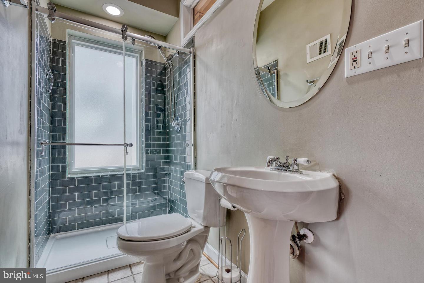 1754 Clarkson Street Baltimore, MD 21230 - Photo 23 of 35 a bathroom with a sink toilet and shower