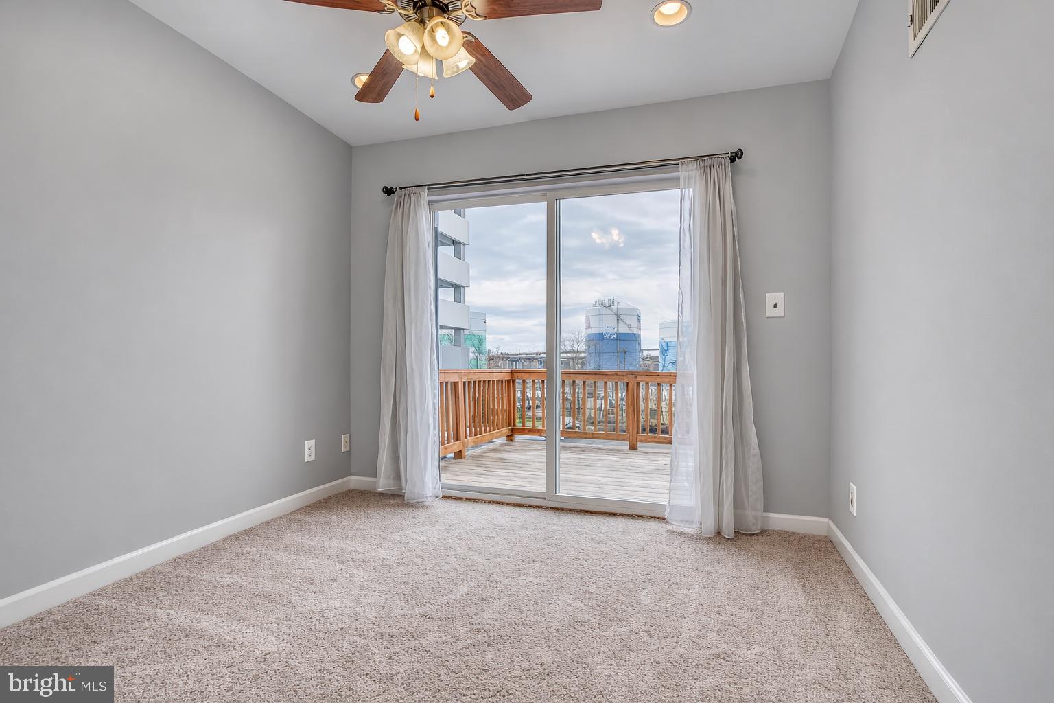 1754 Clarkson Street Baltimore, MD 21230 - Photo 26 of 35 an empty room with chandelier fan and windows