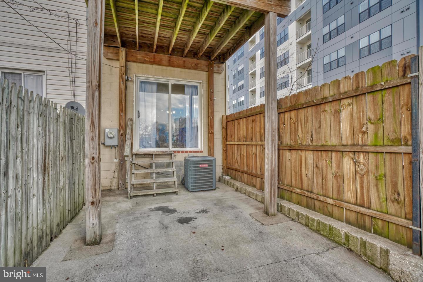 1754 Clarkson Street Baltimore, MD 21230 - Photo 30 of 35 a view of a porch with wooden floor and iron stairs