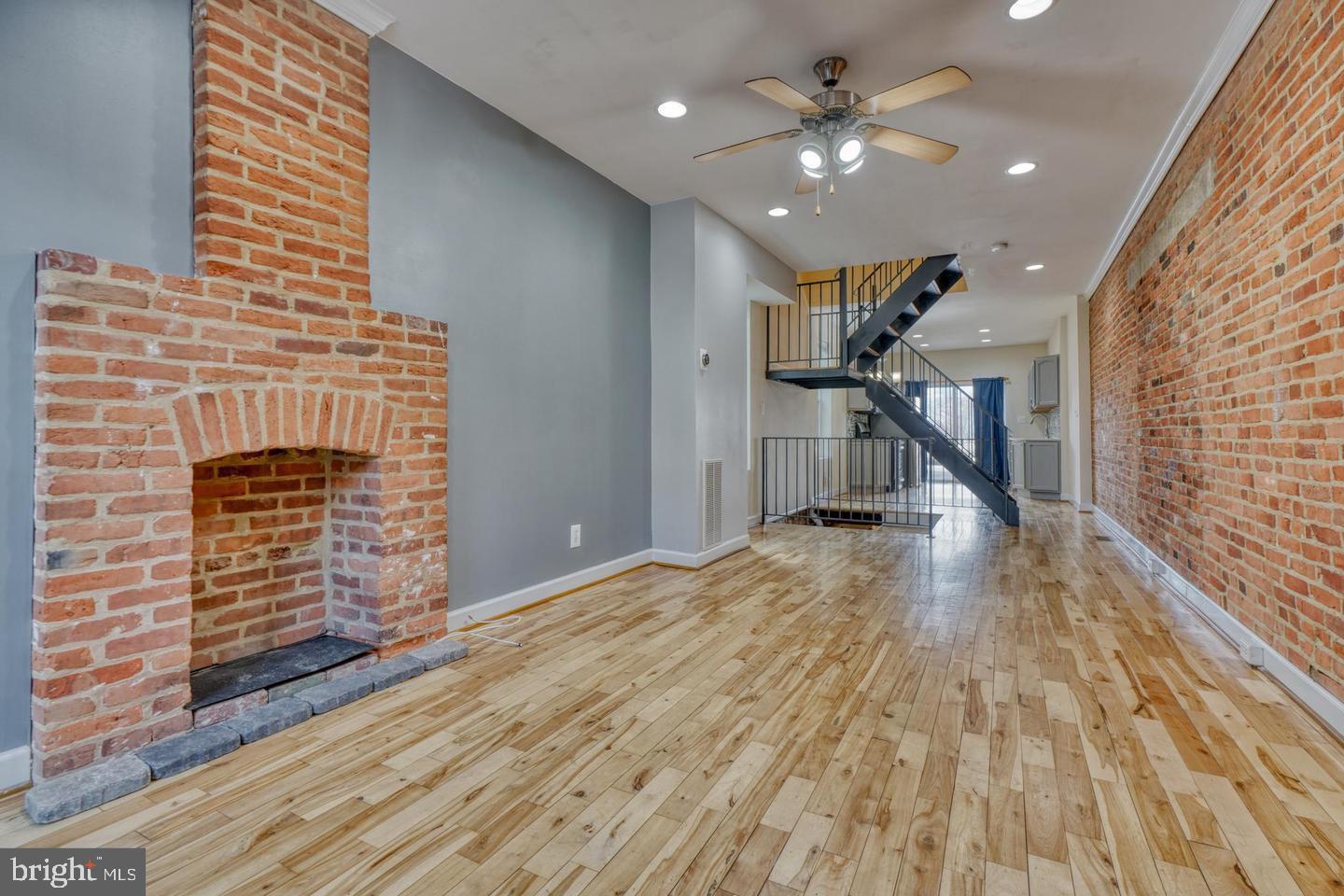 1754 Clarkson Street Baltimore, MD 21230 - Photo 5 of 35 a view of empty room with a fireplace and wooden floor