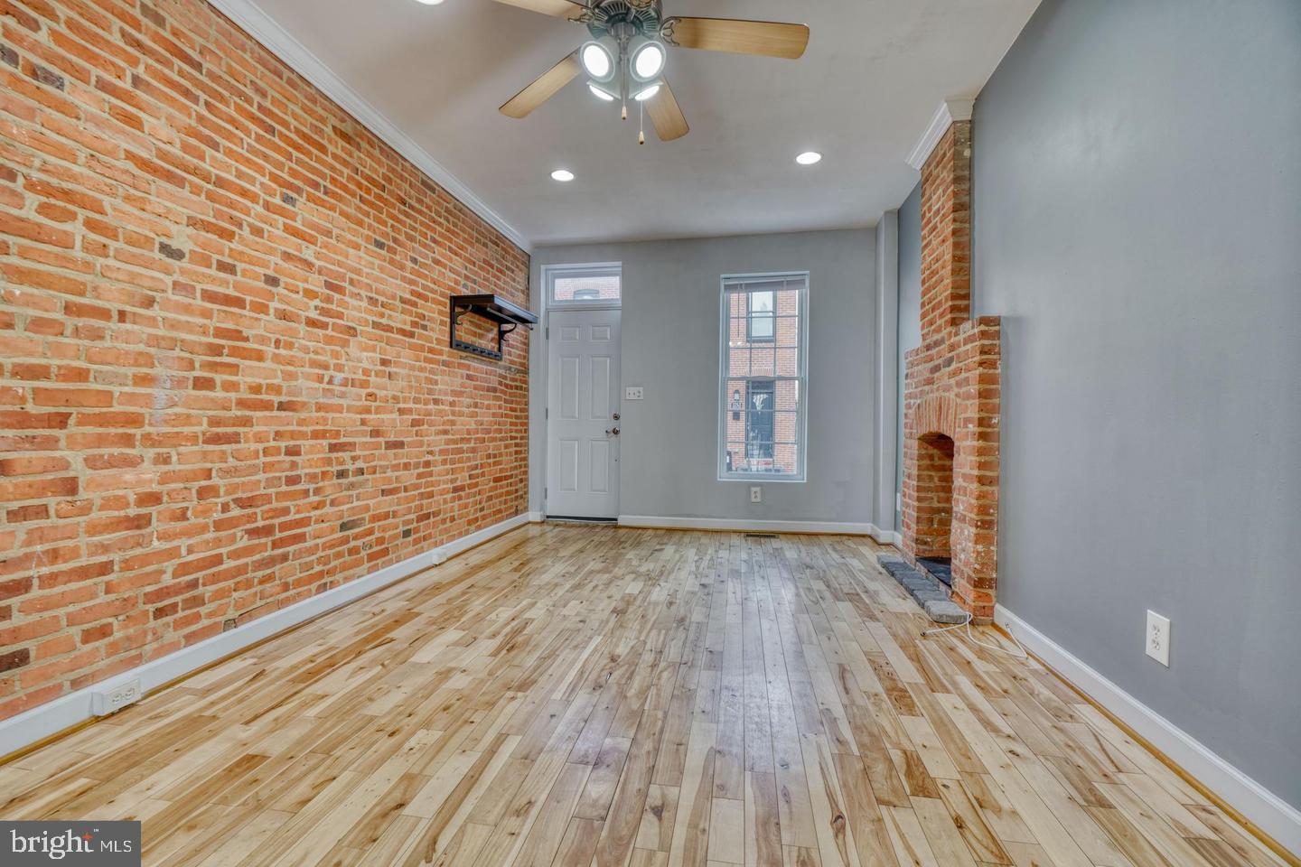 1754 Clarkson Street Baltimore, MD 21230 - Photo 7 of 35 a view of an empty room with wooden floor and a window