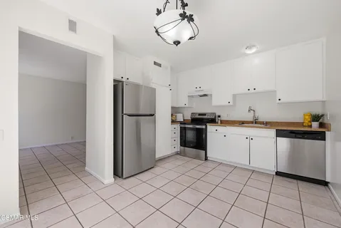 a kitchen with a refrigerator a sink and dishwasher