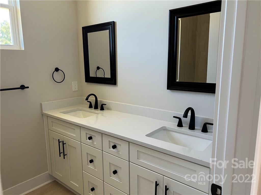 5817 Laney Rogers Road, Unit 5 Monroe, NC 28112 - Photo 13 of 14 a bathroom with a sink and a mirror